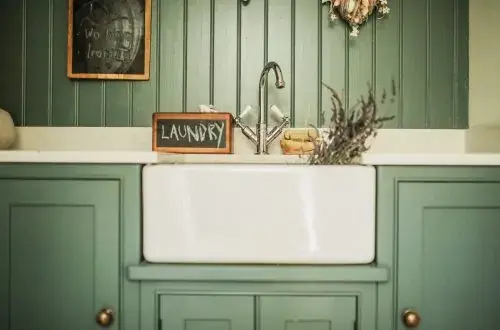 Belfast sink in laundry room with a chalk board with the word laundry written on it